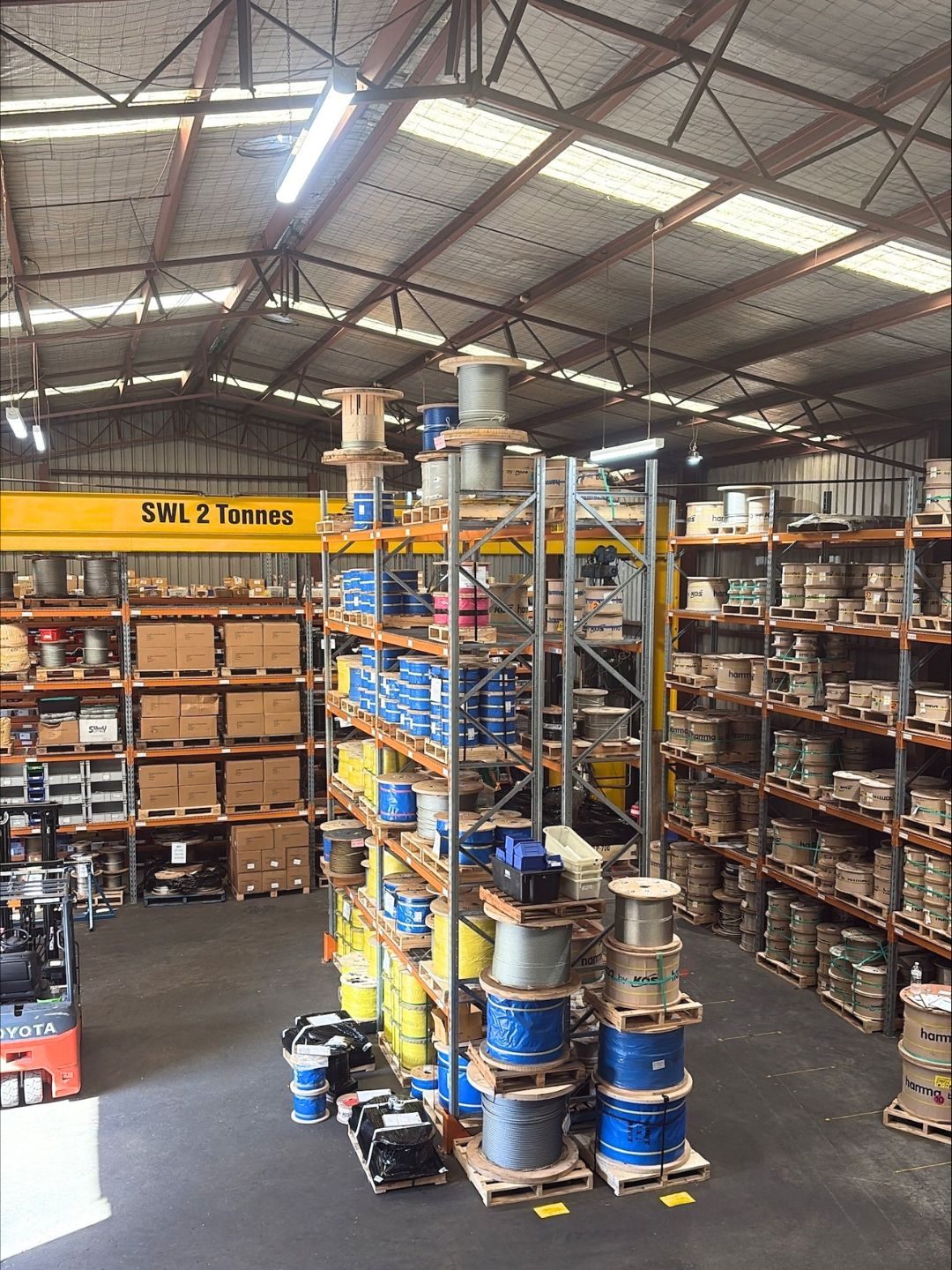 SLE team member selecting synthetic round slings from the warehouse racking at Mount Kuring-gai